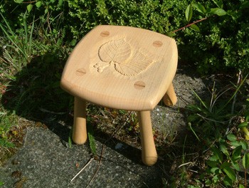 Child's stool in lime with carved lime leaves